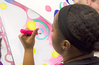 young girl coloring umbrella