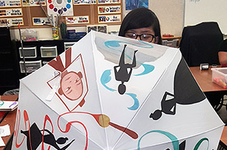 young girl behind umbrella